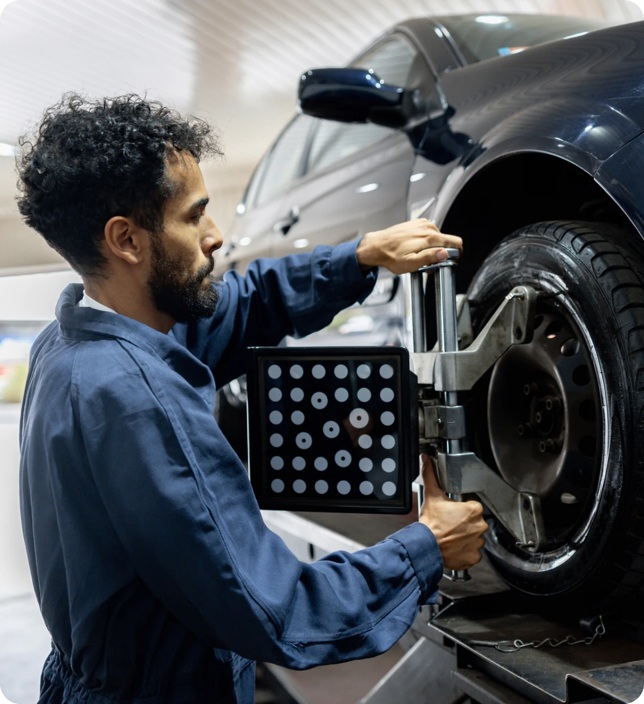Technician performing vehicle wheel calibration