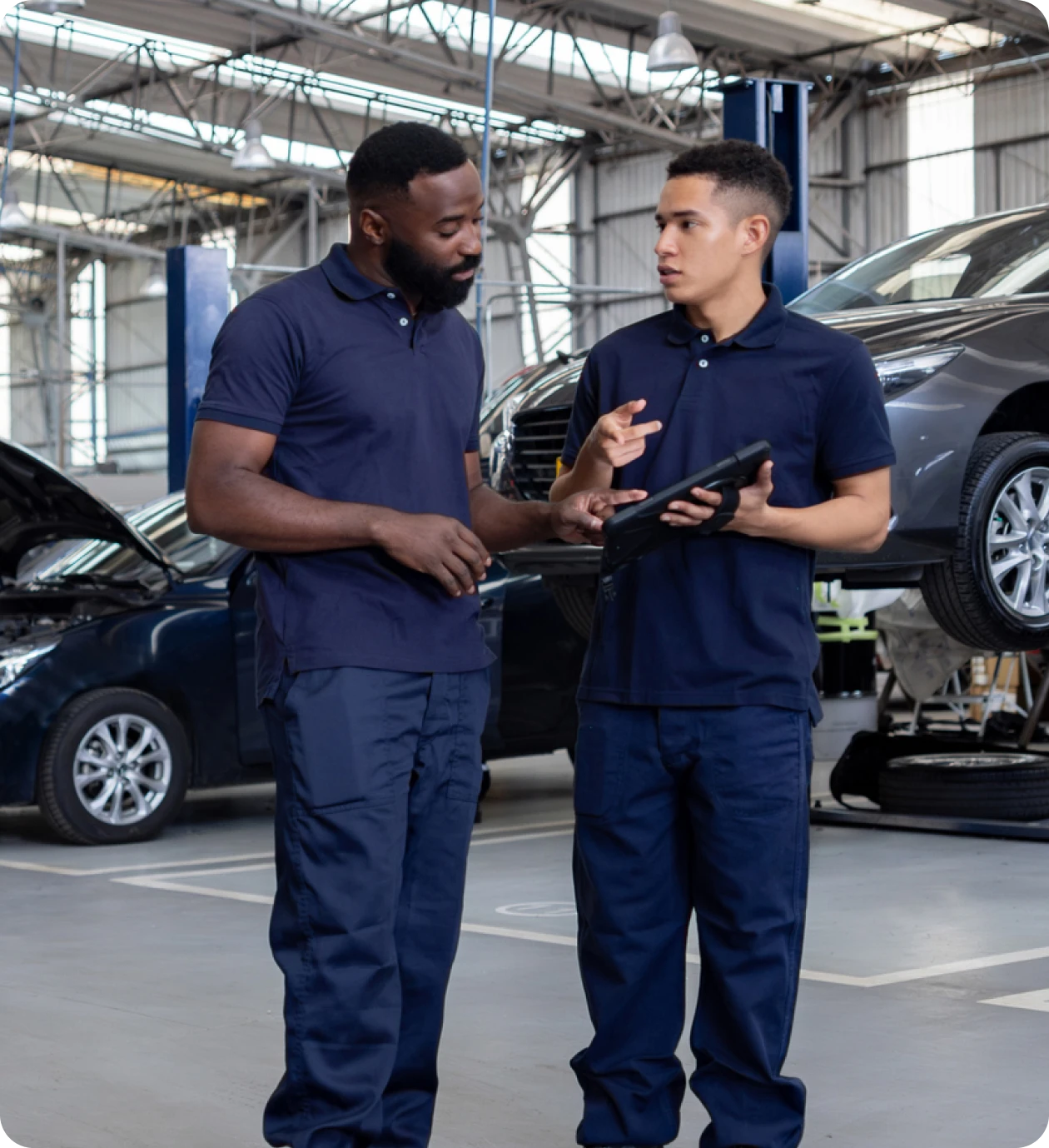 Auto technicians reviewing tablet data