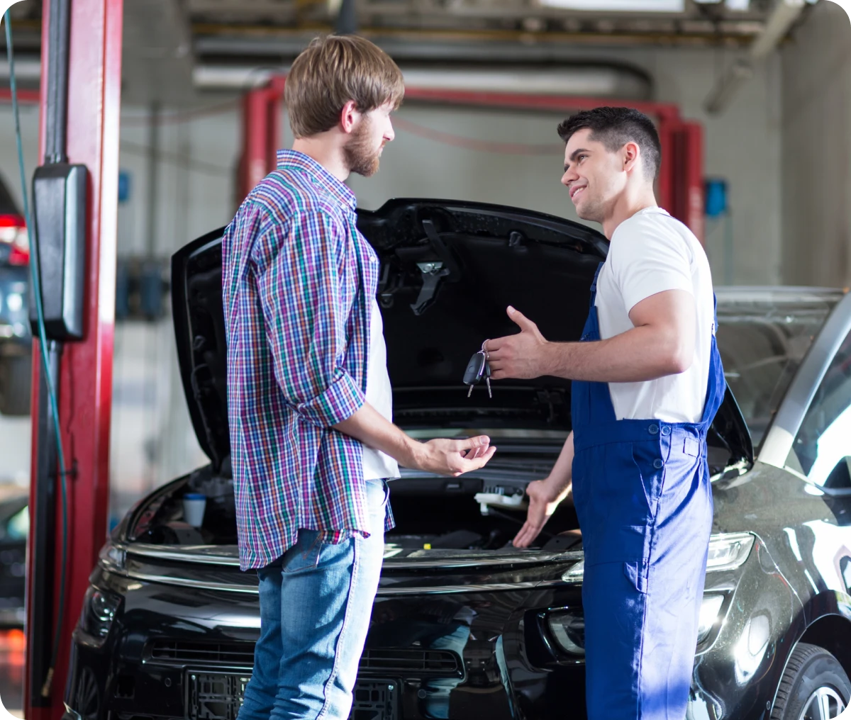 Mechanic discussing with customer in garage