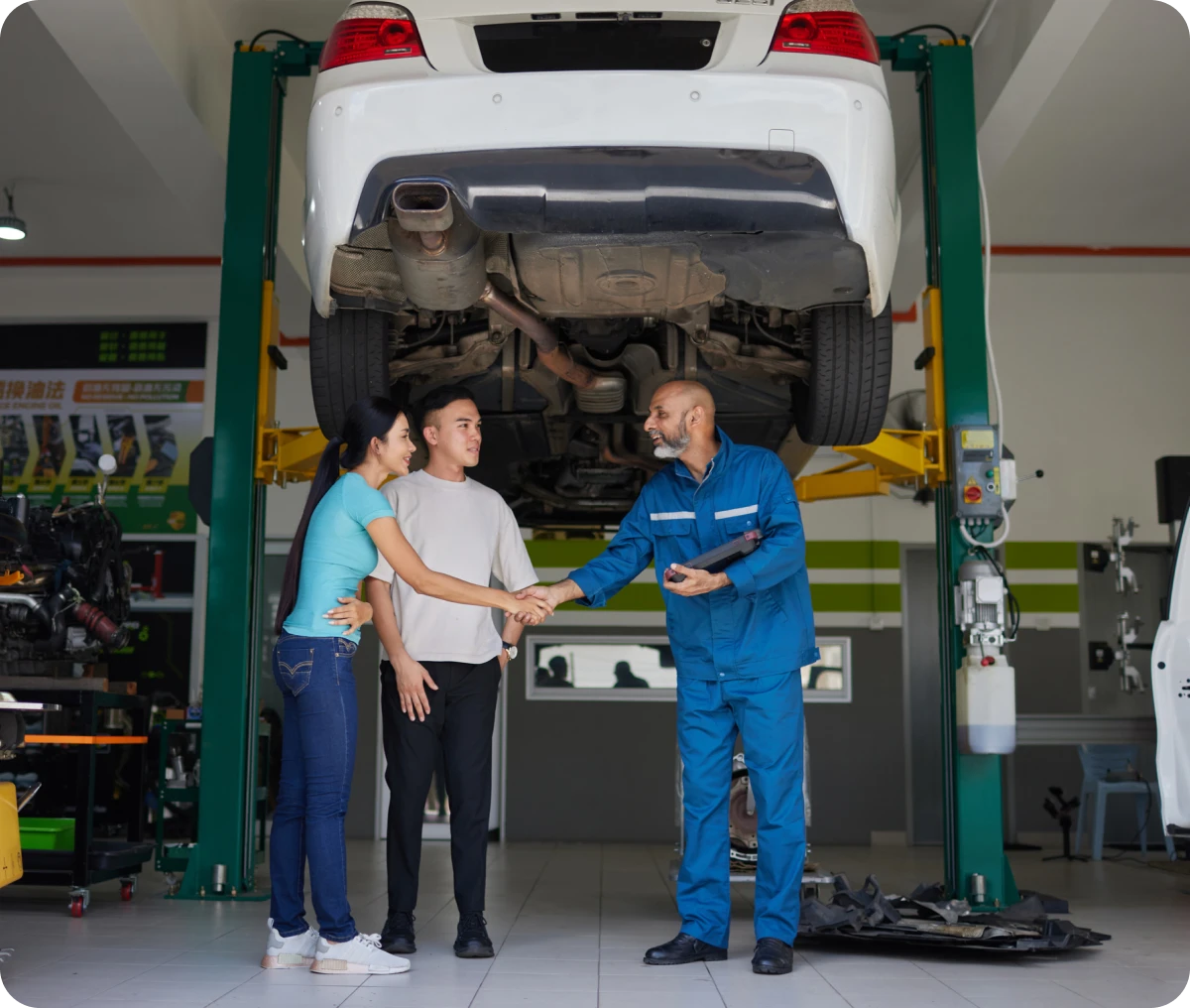 Mechanic shaking hands with customers